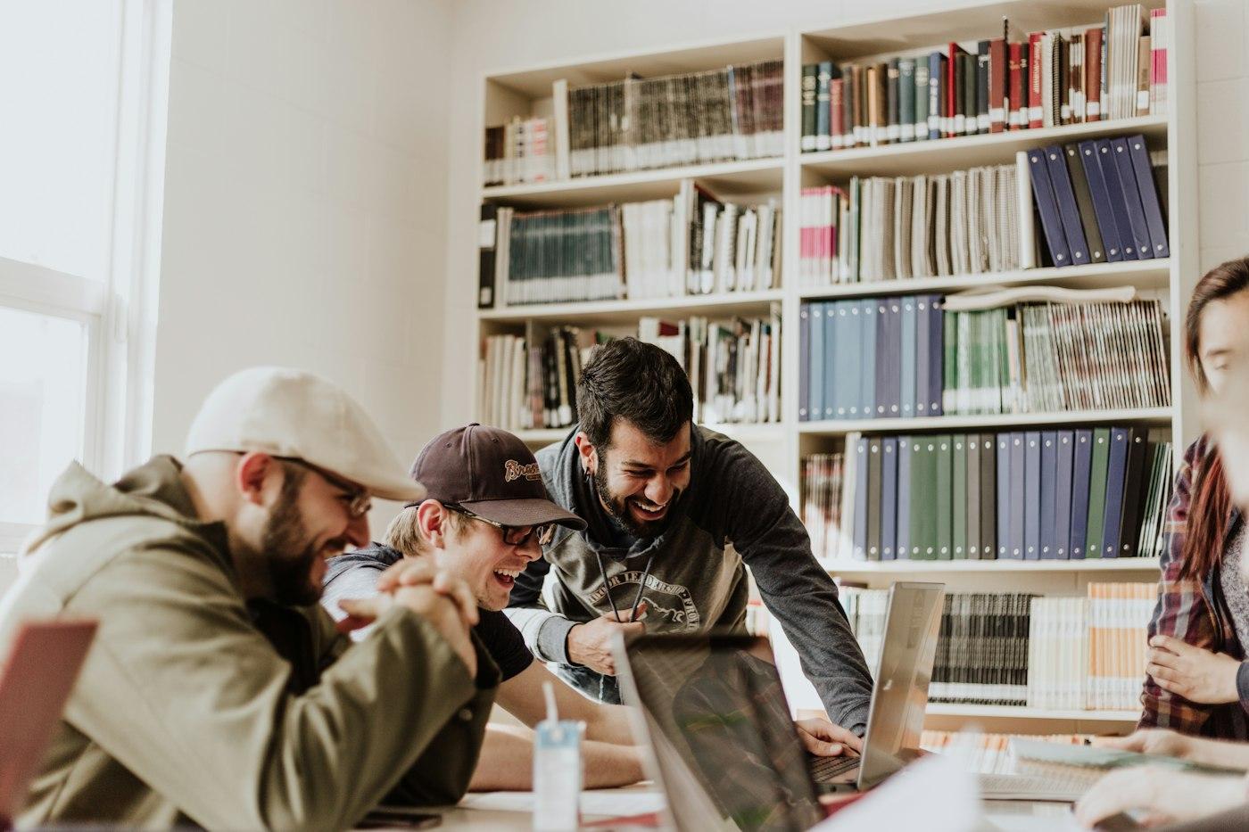 University students collaborating on campus with laptops